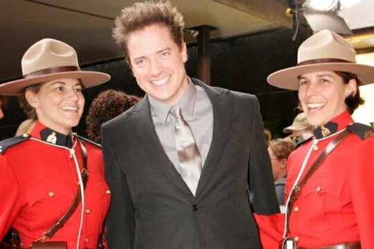 Brendan Fraser with mounties at the 2006 Red Carpet event